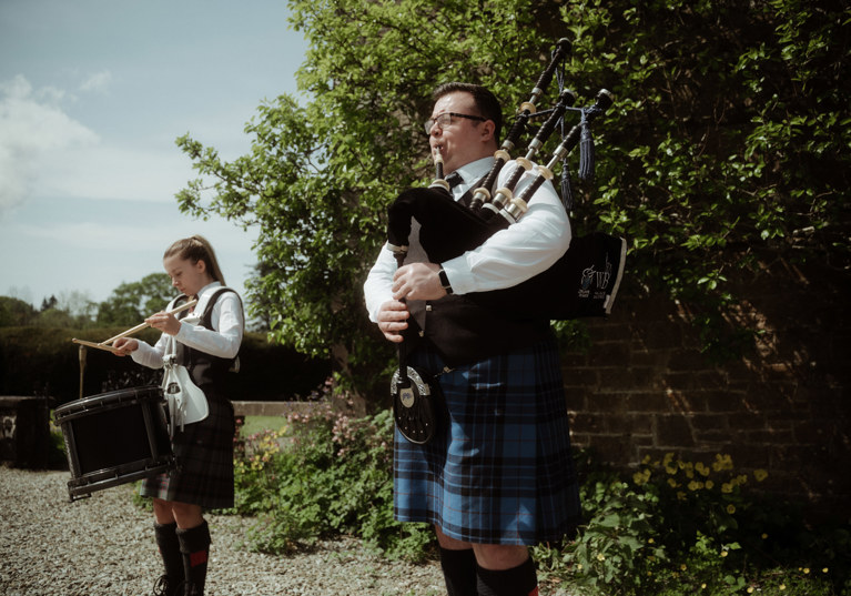 Bagpipe player and drummer in kilts organised by White Heather Wedding & Event Planning Services